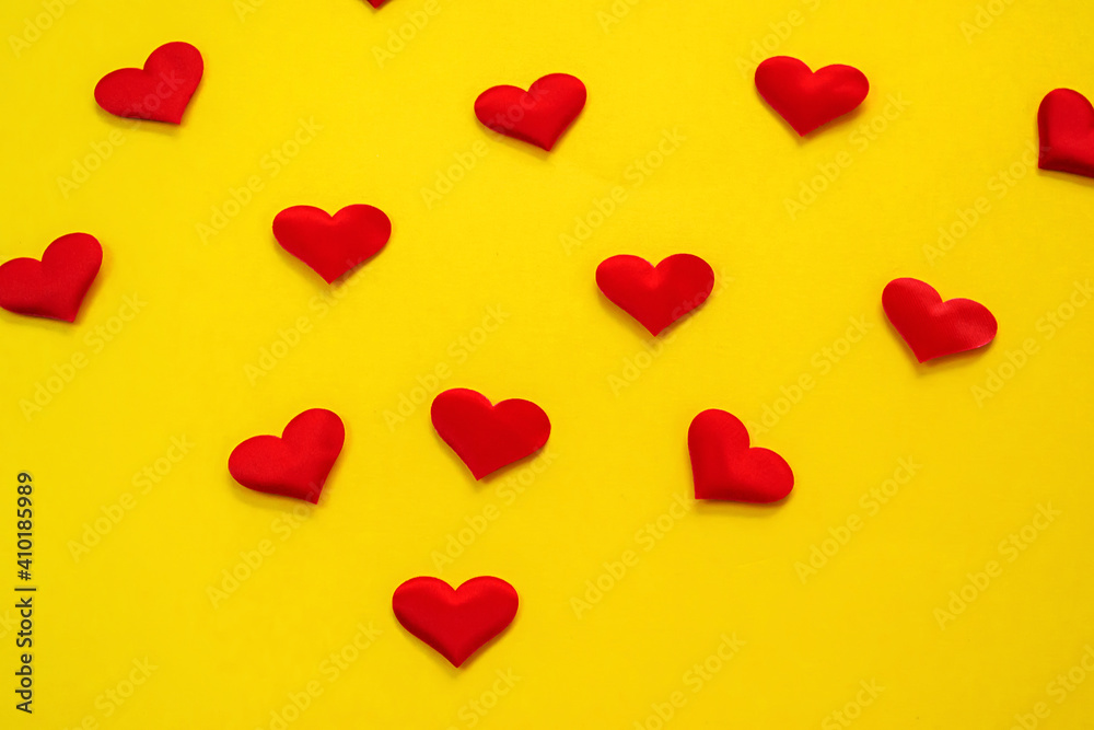 Hands on a yellow background with a heart, love. Selective focus.