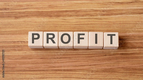 profit text written on wooden block on wooden background
