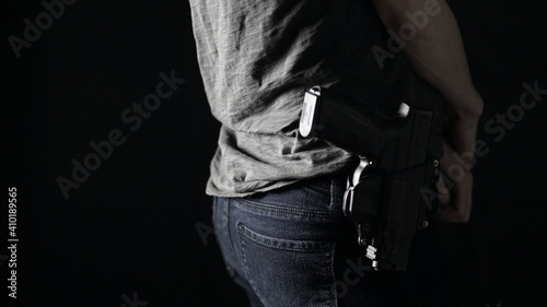 A woman openly carrying a handgun on her hip