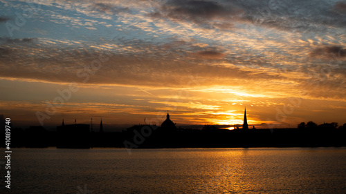 Beautiful sunset featuring the outline of Copenhagen landmarks and waterline