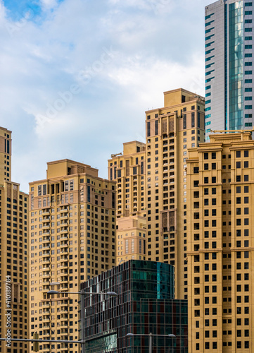 Yellow Dubai Marina skyscrapers in UAE. Multistory residential Estate