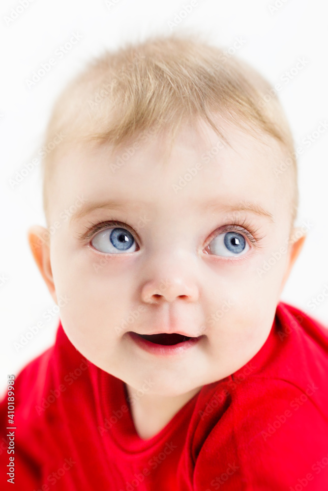 The face of a beautiful child with blue eyes and long eyelashes, close-up. The face of a beautiful child with blue eyes and long eyelashes, close-up.