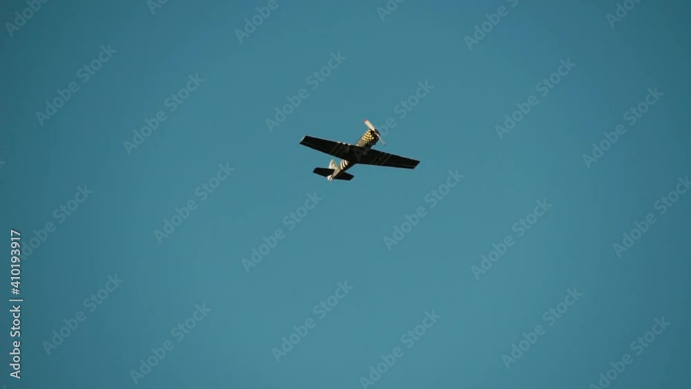old retro single-engine propeller airplane plane dives and attacks the enemy flies in the sky low above the ground world war ii