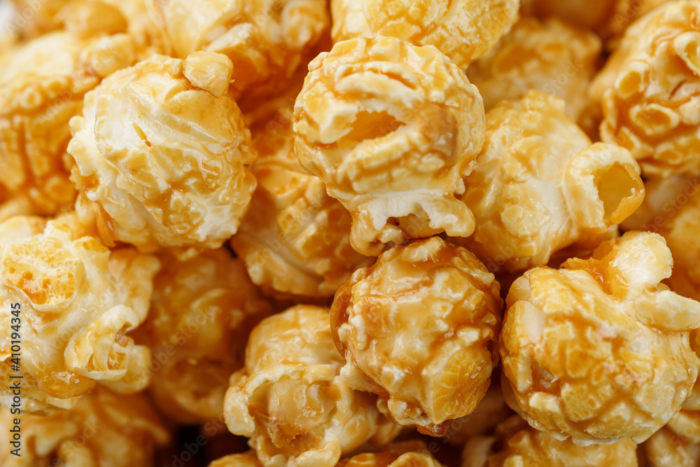 Popcorn in caramel glaze macro as a background. Popcorn in caramel glaze macro as a background.