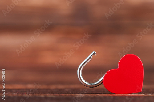 Valentine heart shaped padlock on brown wooden table