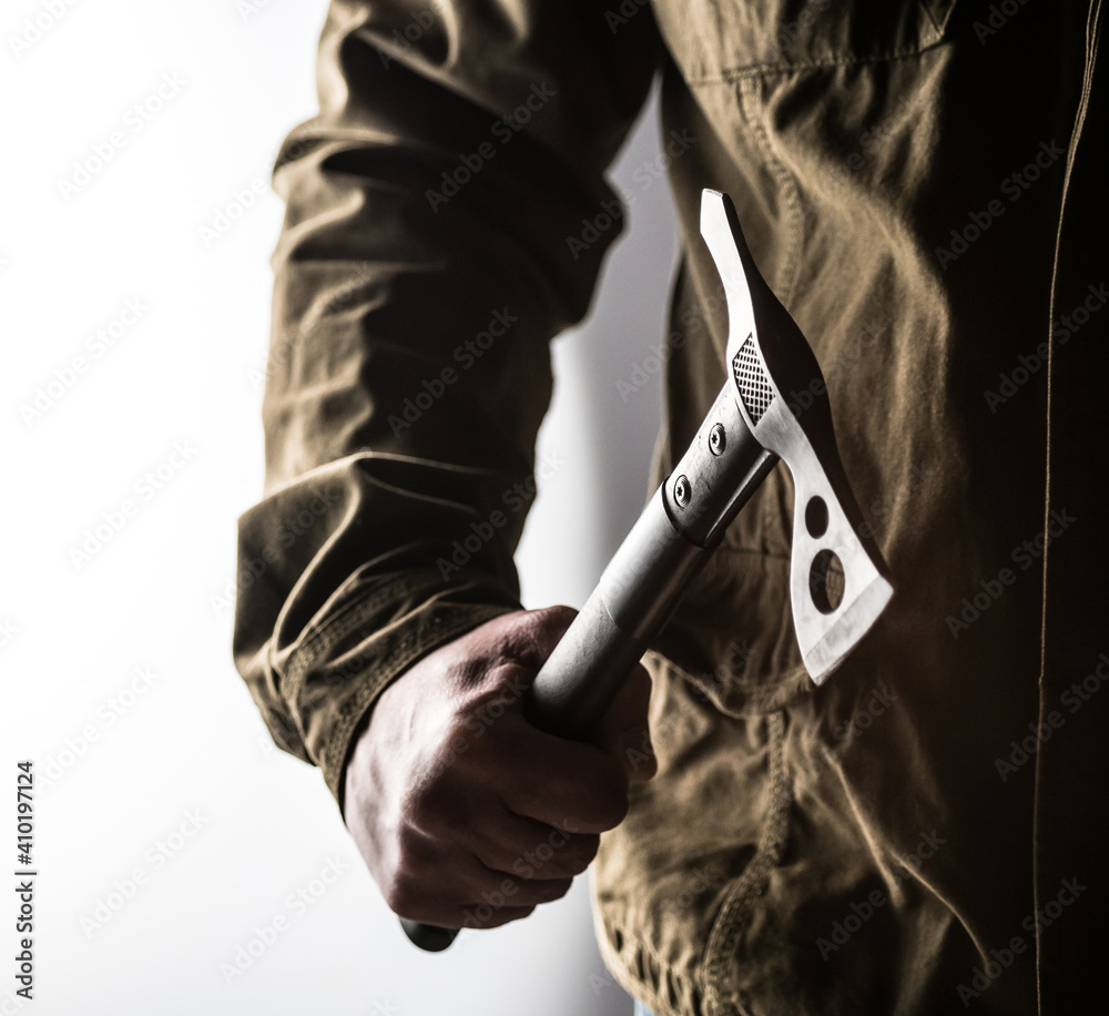 Man holding a tactical tomahawk Man holding a tactical tomahawk