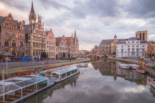The beautiful historic old town of Ghent, Belgium along the Leie Canal at dusk.