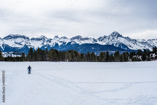 solo skier in front of mountain range