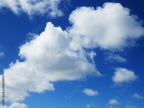 Beautiful blue sky and Caribbean white cloud background. Cottony textured clouds in tropical sky. Summer sky with cumulus clouds in the French West Indies.