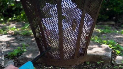 Lighting and Burning Paper Trash in Metal Fire Cage