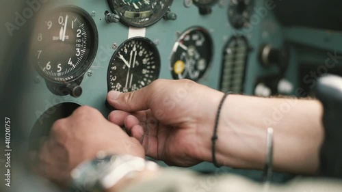 the pilot in the cockpit prepares for flight and checks the aerometric instruments altimeter artificial horizon heading indicator airspeed indicator variometer turn and slip indicator photo