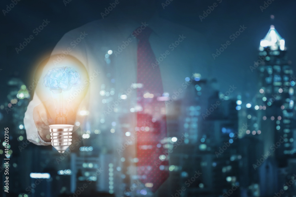 Businessman hand touching Light bulb with brain as business idea concept. Businessman hand touching Light bulb with brain as business idea concept.