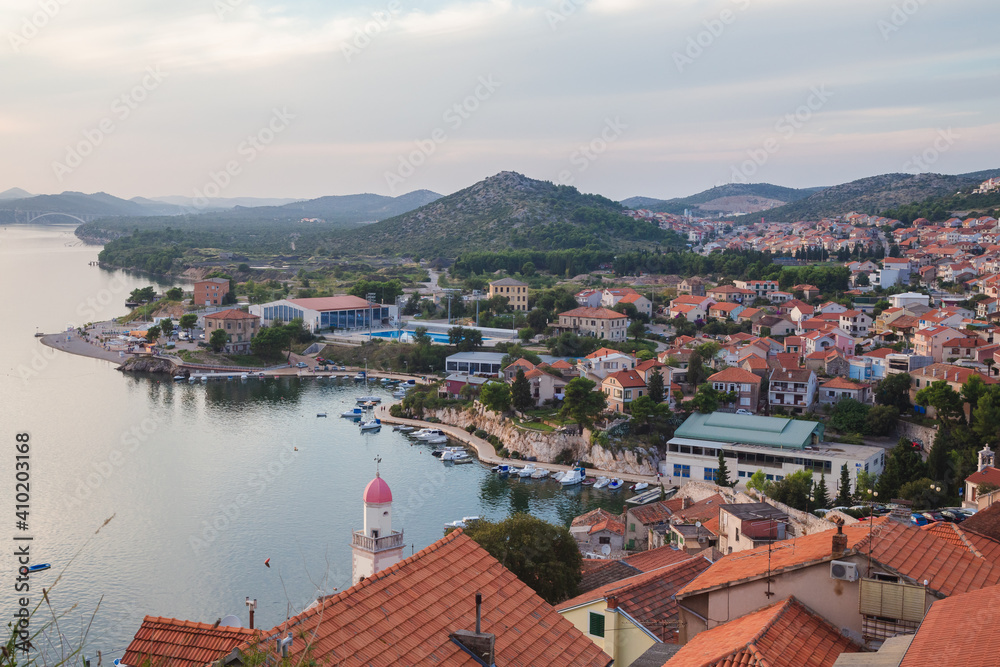 A view of Sibenik on the Adriatic coast in Croatia captured from atop the hillside old town looking to the hills and the sea.