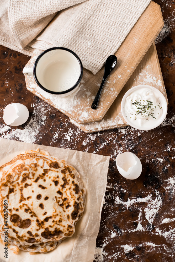 pancakes with sour cream on the table. Flat lay top-down pancakes with sour cream on the table. Flat lay top-down