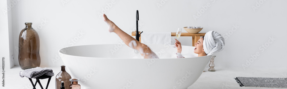 Cheerful woman with glass of champagne bathing at home, banner - obrazy, fototapety, plakaty 