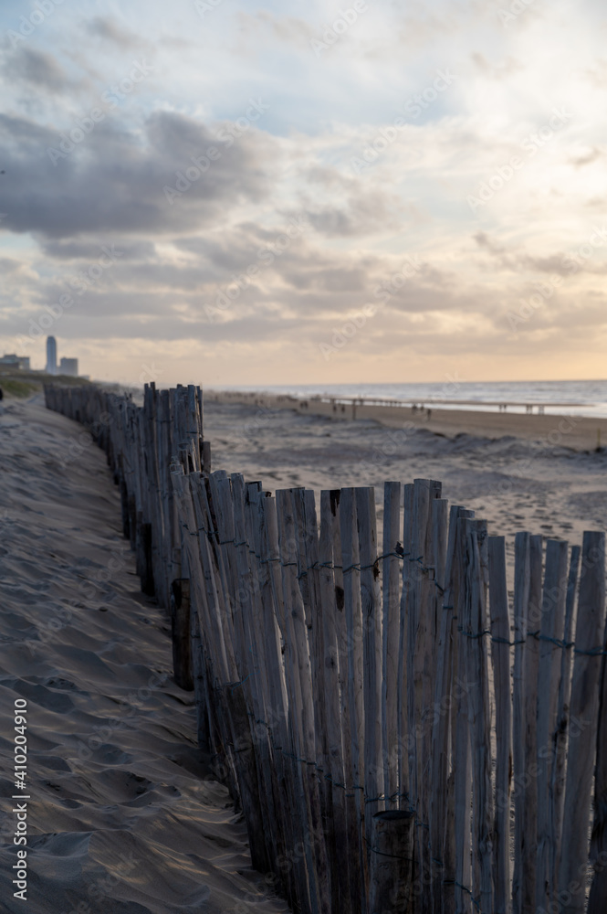 Sand fence on wide windy beach of North sea near Zandvoort in Netherlands Sand fence on wide windy beach of North sea near Zandvoort in Netherlands