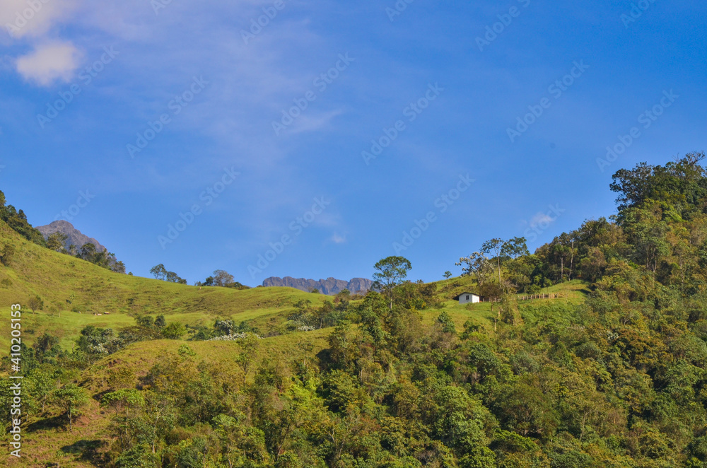 landscape with mountains and a cabin