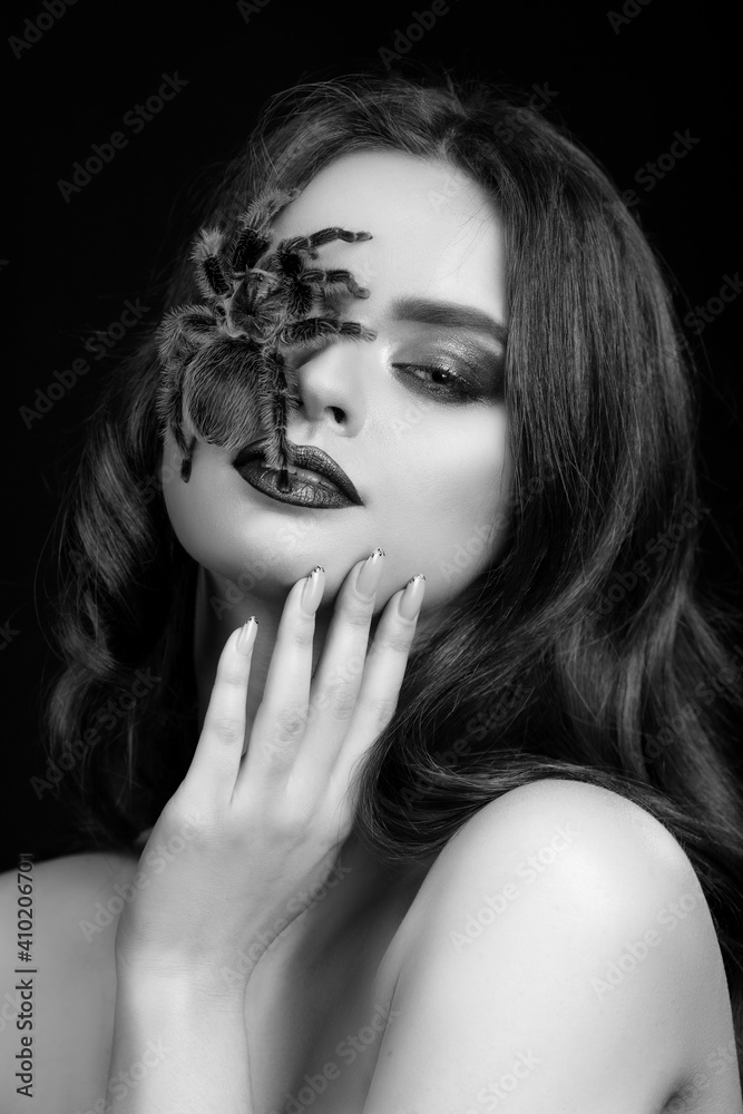 girl brunette green make-up eyes gaze on black pink background black and white close portrait with brown spider on face tarantula girl brunette green make-up eyes gaze on black pink background black and white close portrait with brown spider on face tarantula