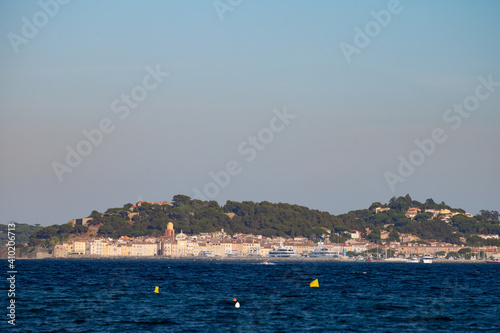 Blue water of Gulf of Saint-Tropez with outlines of Saint-Tropez town on background, French Riviera, France