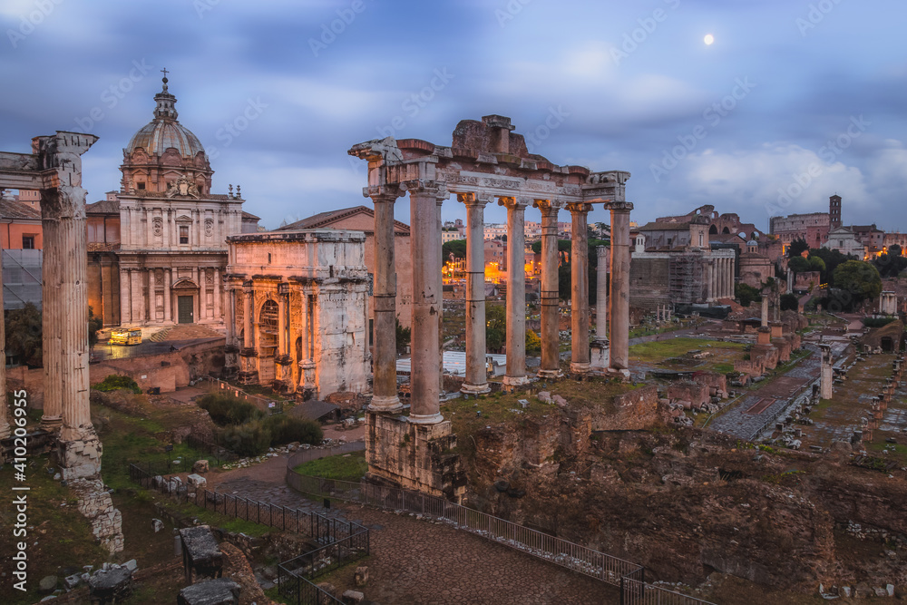 Evening view of historic ruins of the Roman Forum and Palatino Hill in Rome, Italy.