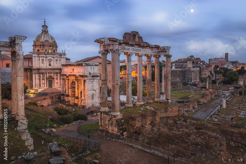 Evening view of historic ruins of the Roman Forum and Palatino Hill in Rome, Italy.