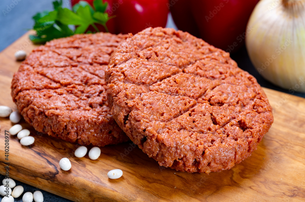 Tasty uncooked burger made with vegetarian plant based imitation minced meat ready for grill