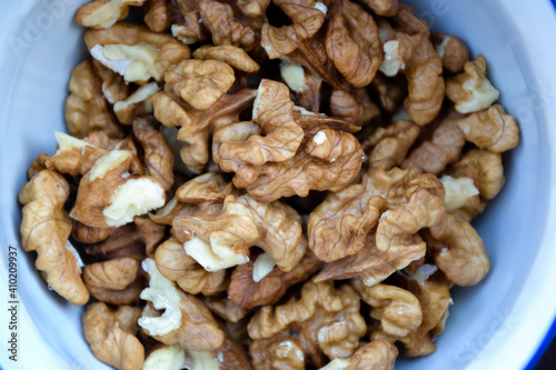 Walnuts harvest on vintage metal background. Walnut kernels from village garden. Organic autumn nuts harvest.