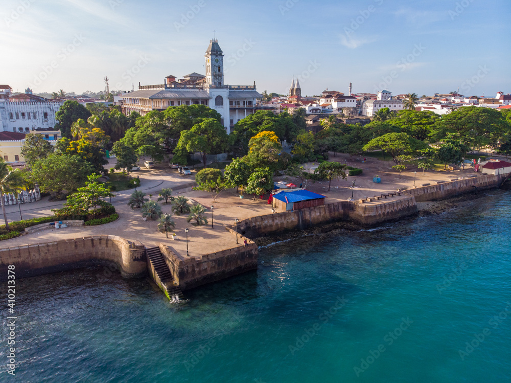 Zanzibar Aerial Shot of Stone Town Embarkment with Traditional Dhow Fisherman Boats in the Ocean at Sunrise Morning Time