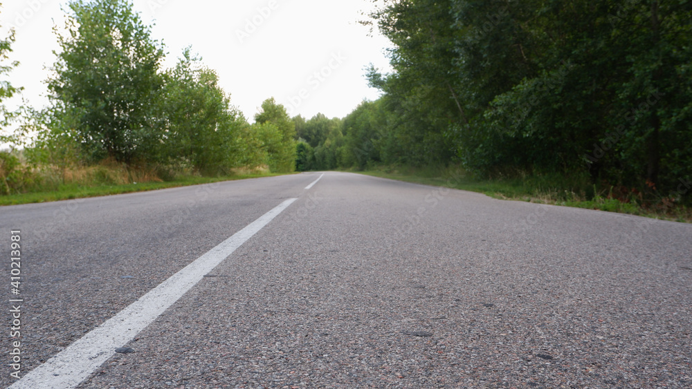 Asphalt gray road among greenery low plan