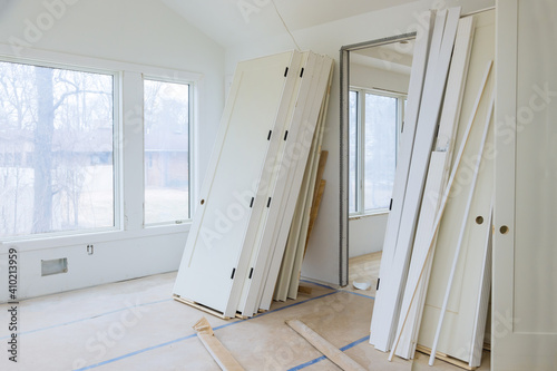 Konstfotografi Interior wooden stacker door installation apartment building, wait installation