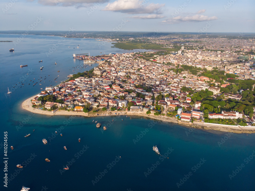 Aerial. Stone town, Zanzibar, Tanzania. Flock of Show Ships near the Zanzibar Coastline in Stone Town on Blue Transparent Water