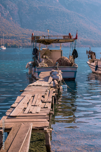 Traditional Turkish Fishing boat tethered to a rickety pier at Akbuk Limani, Gokova, Turley photo