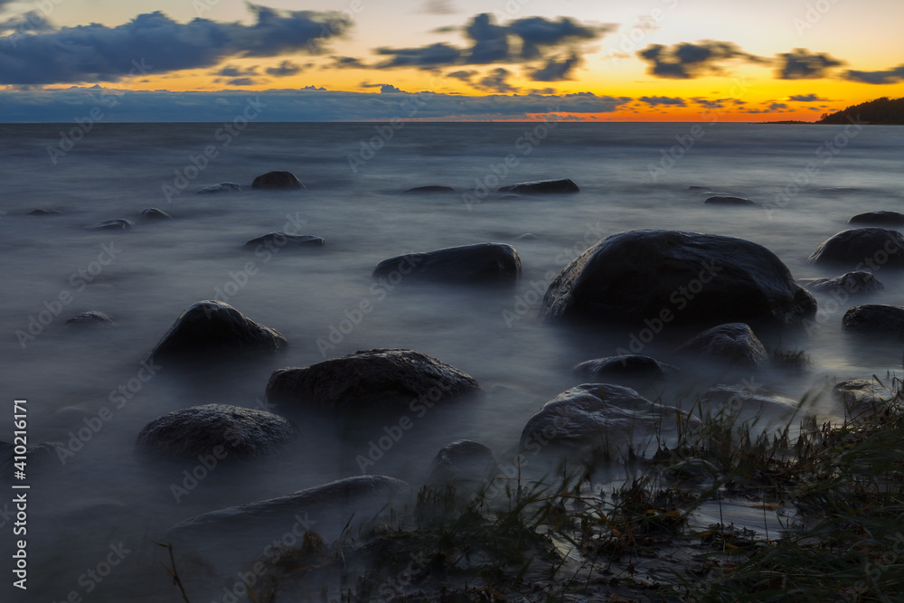 Rocky sea coast at blue hour. Long exposure. Baltic sea.