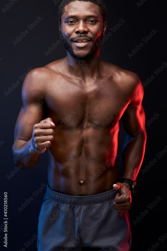 athlete man running, shirtless african sportsman wants to be the first in competition, isolated on black background