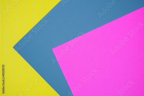 Blue, pink and yellow three tone color paper background with stripes. Abstract background modern hipster futuristic. Texture design