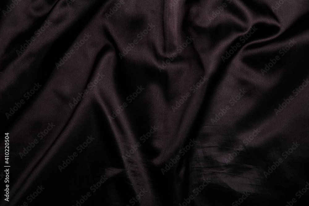 Fototapeta premium Suit or jacket lining, black shiny smooth wrinkled fabric texture, background or backdrop.