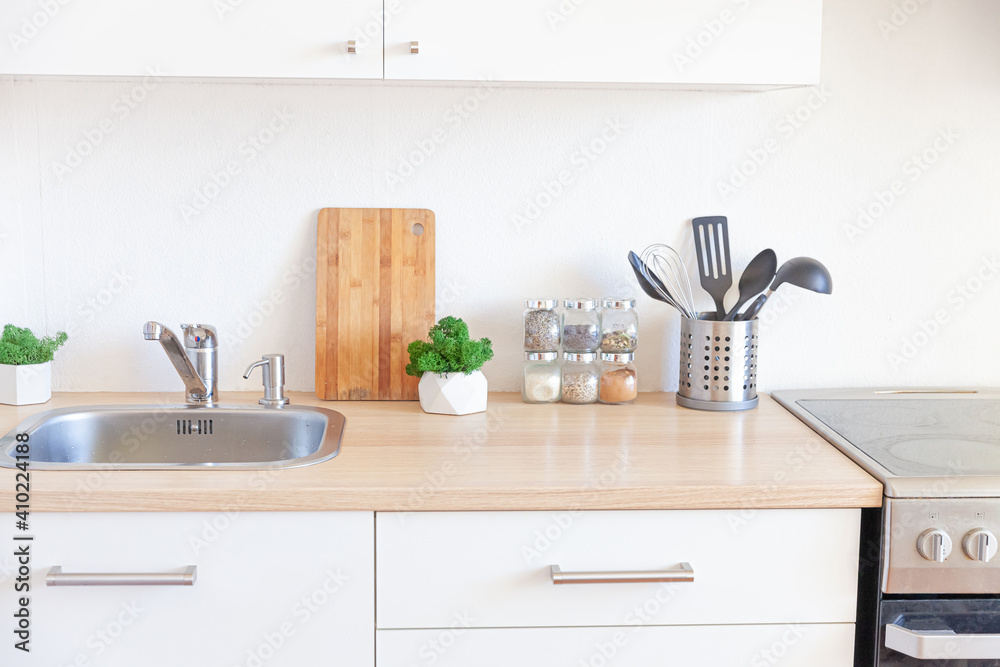 Fototapeta premium Scandinavian classic minimalistic kitchen with white and wooden details. Modern white kitchen clean contemporary style interior design.
