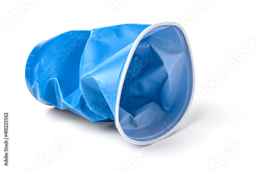 crushed blue plastic cup isolated on a white background