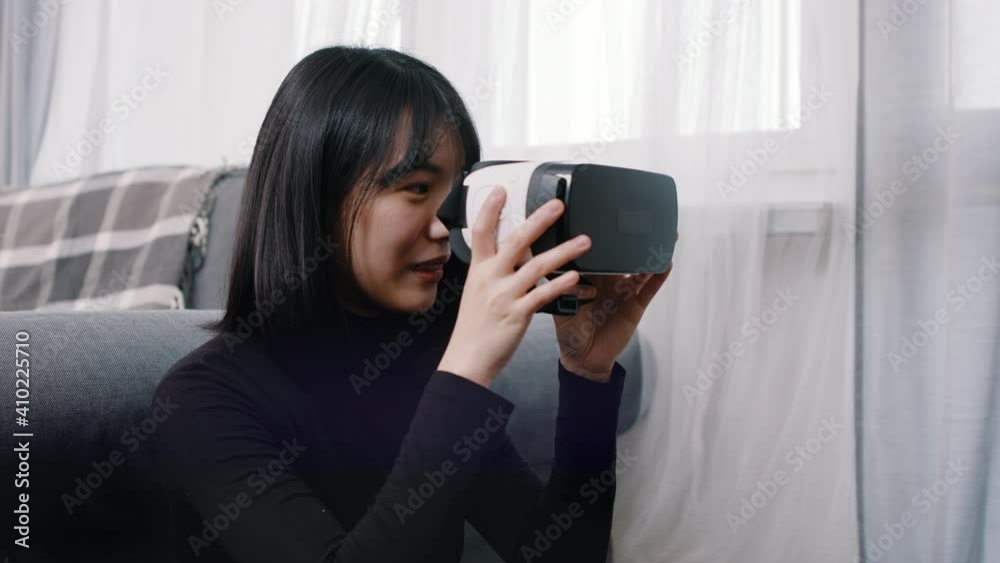 Young asian woman putting on VR googles. High quality 4k footage Young asian woman putting on VR googles. High quality 4k footage