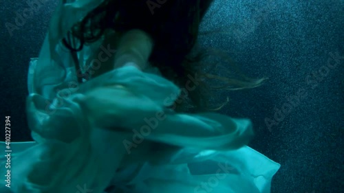beautiful girl in colorful dresses under the water