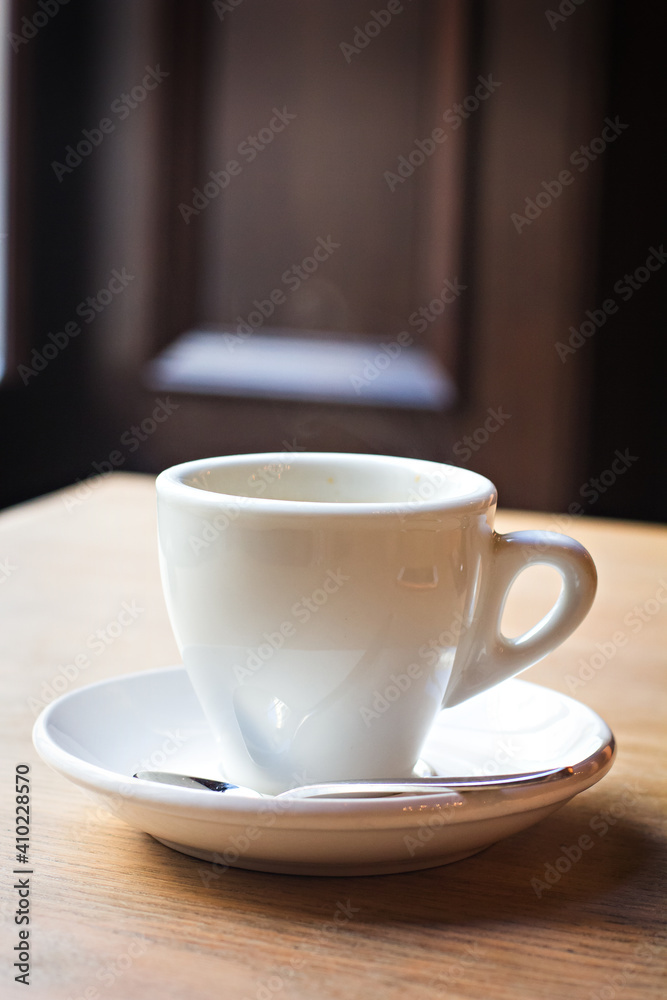 a cup of espresso on a table in a bar, cafe, restaurant