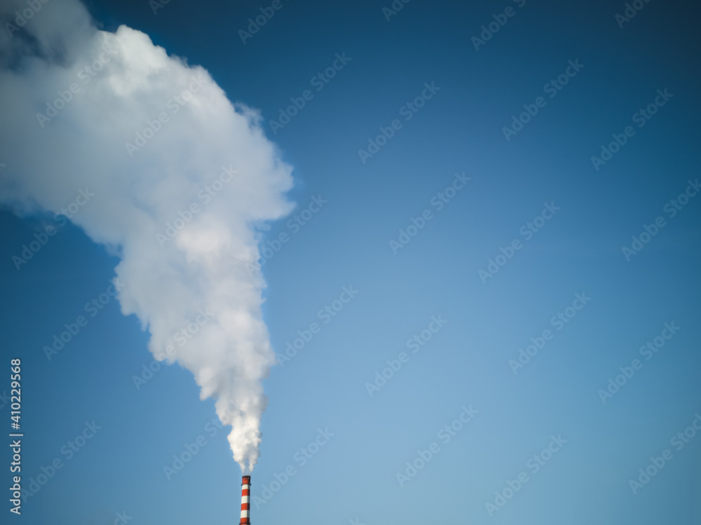 The smokestack of the plant, emitting pollutants into the atmosphere, harming the environment.