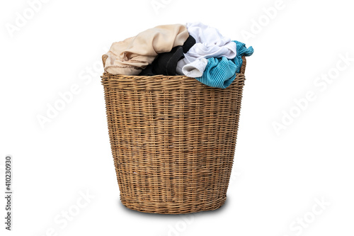 Clothes in a laundry wooden basket isolated on white background. Overflowing laundry basket. clipping path