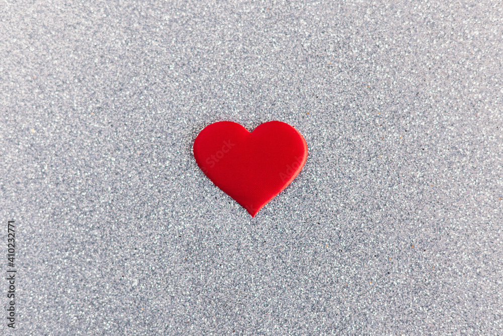 Red heart on a grey sparkle background. Minimal concept for Valentine day. Red heart on a grey sparkle background. Minimal concept for Valentine day.
