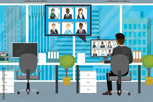 Group video conference. Interior of modern office. Businessman sitting at workplace, rear view. Remote negotiations, video call.