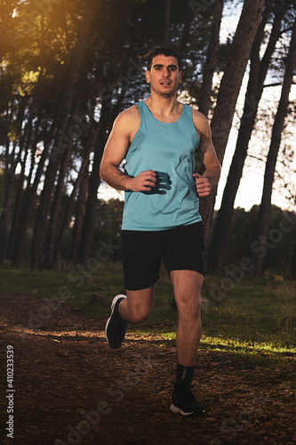
young athlete running in a forest outdoors