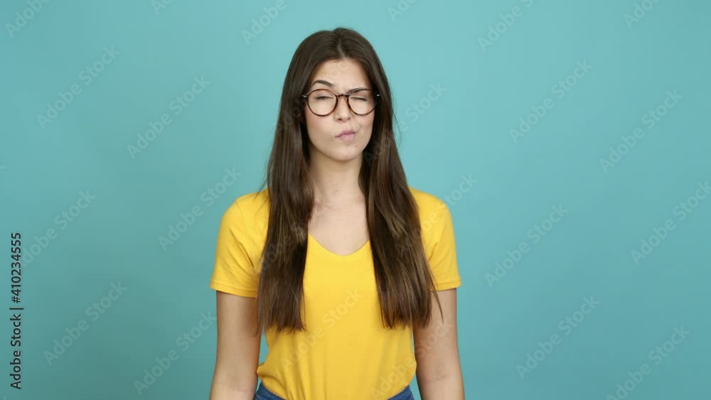 Teenager Brazilian girl with glasses looking side over isolated background Teenager Brazilian girl with glasses looking side over isolated background