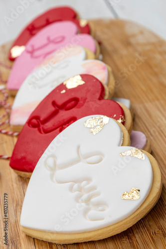 Romantic-themed cookies displayed on a wooden baord