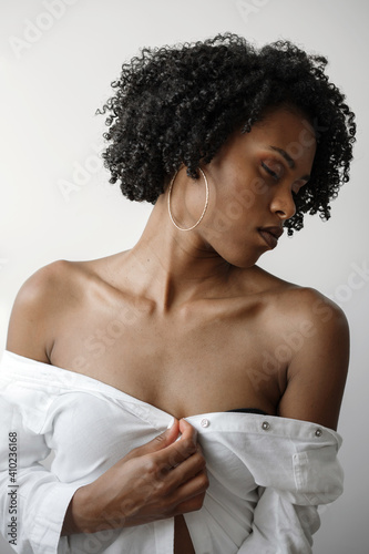 Portrait of a beautiful black woman with curly hair on a white background