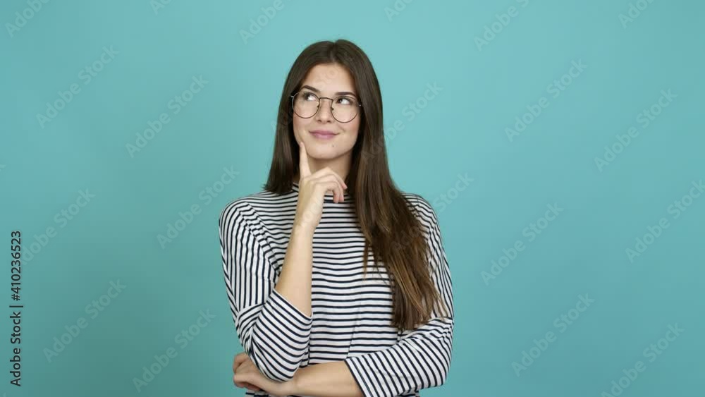 Teenager Brazilian girl with glasses standing and thinking over isolated background Teenager Brazilian girl with glasses standing and thinking over isolated background